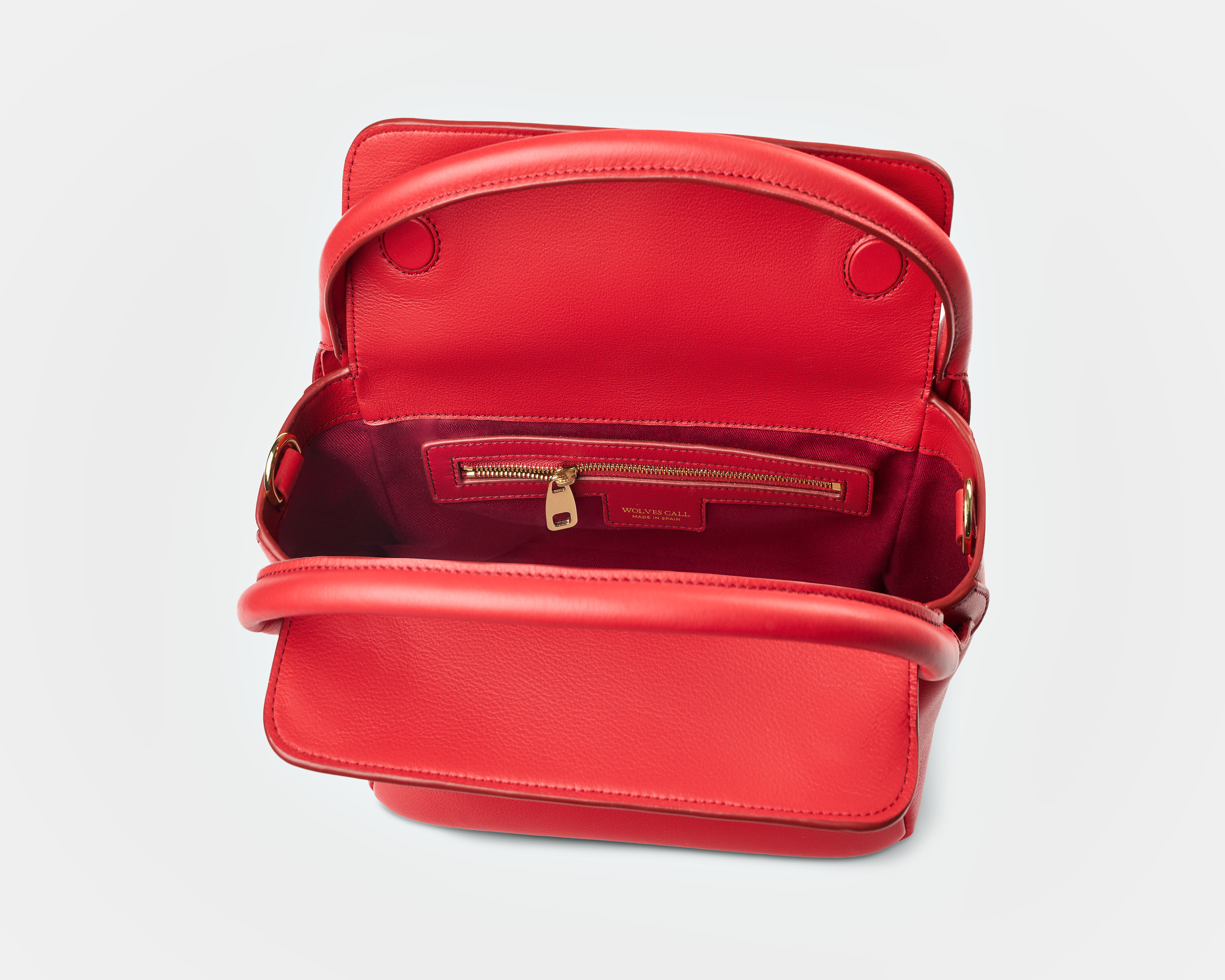 Wolves Call 'The Maria' red handbag open, showing the red satin lining and gold zip pocket