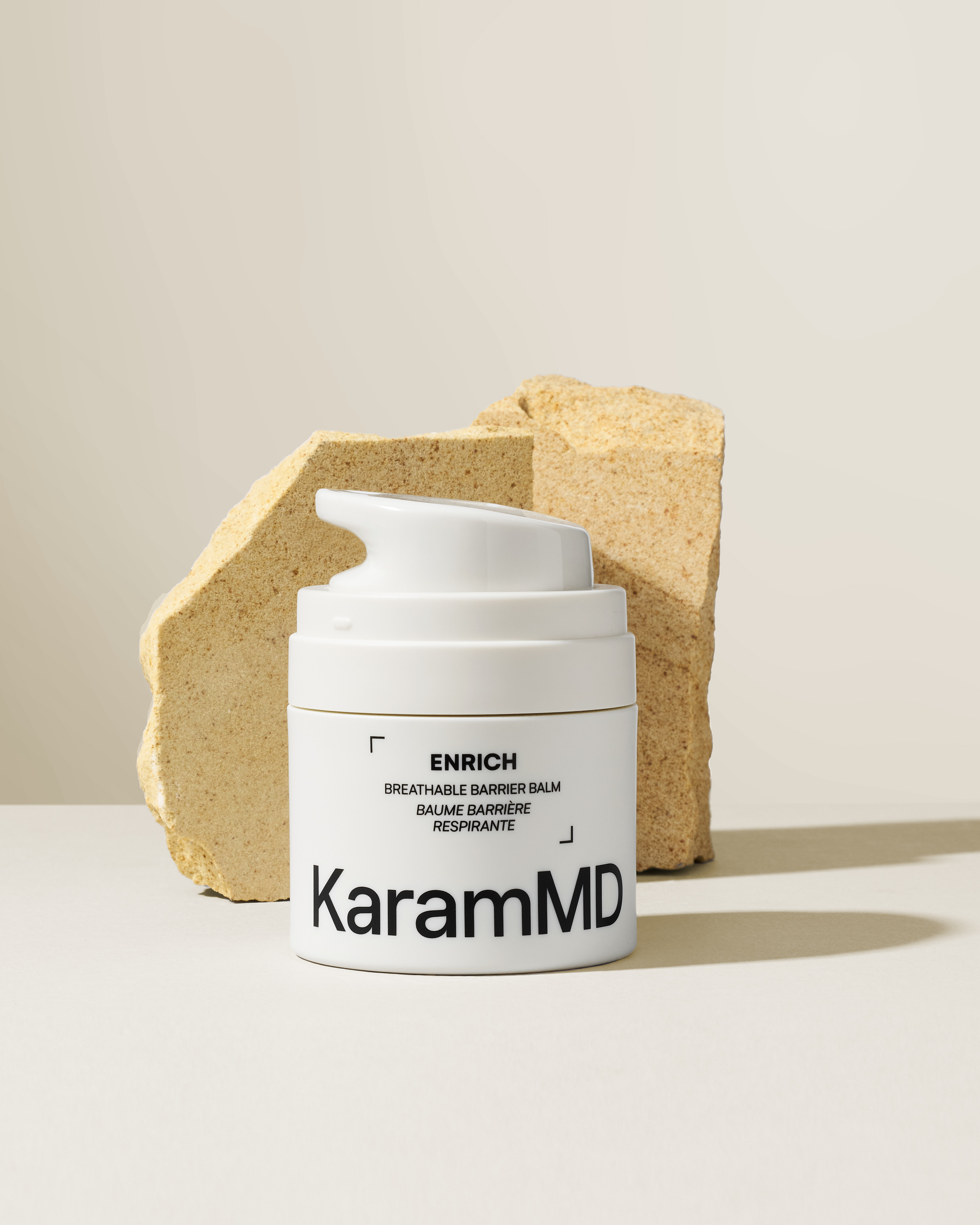 KaramMD Enrich Breathable Barrier Balm on a stone plinth