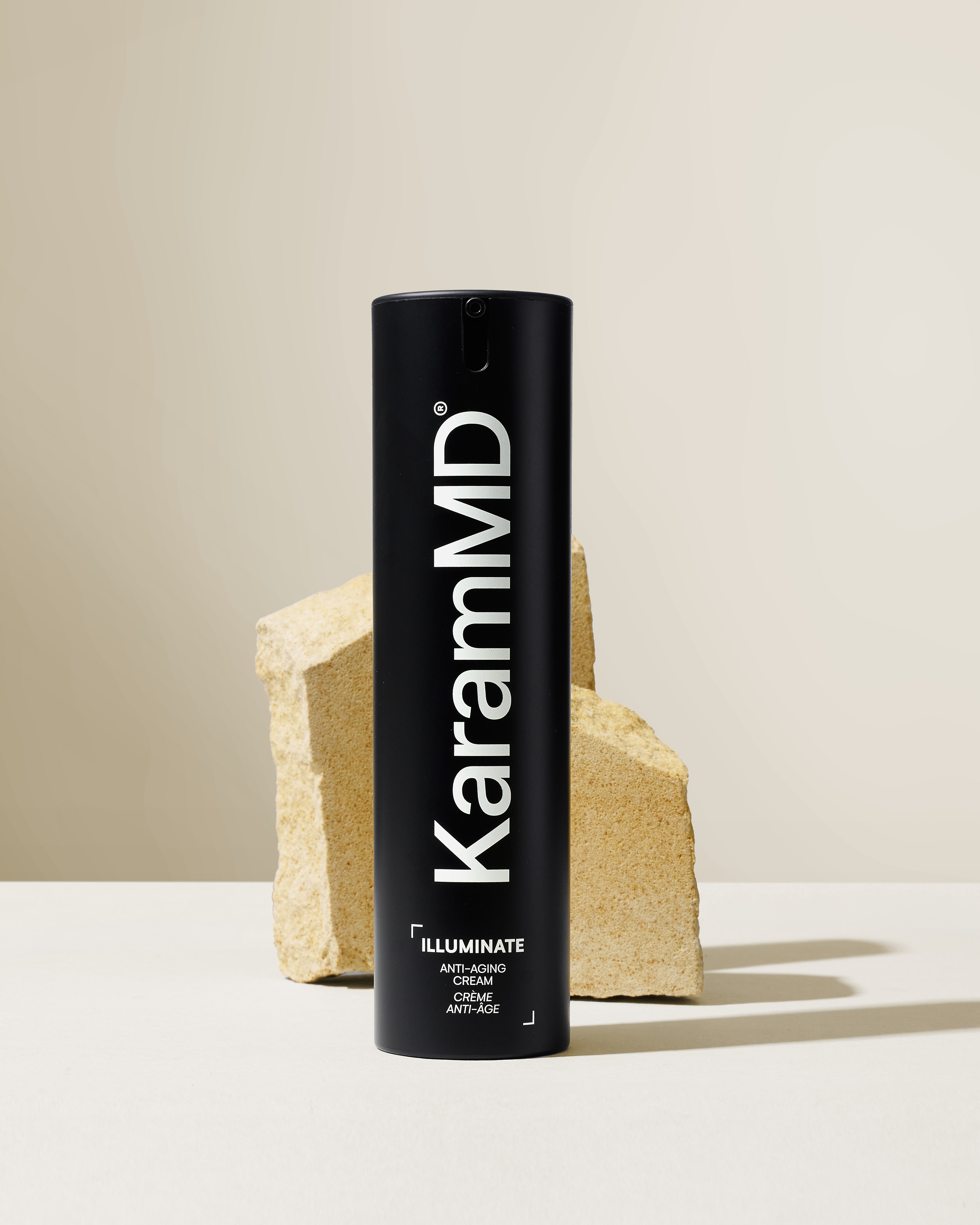 KaramMD Illuminate Anti-Aging Cream on a stone plinth