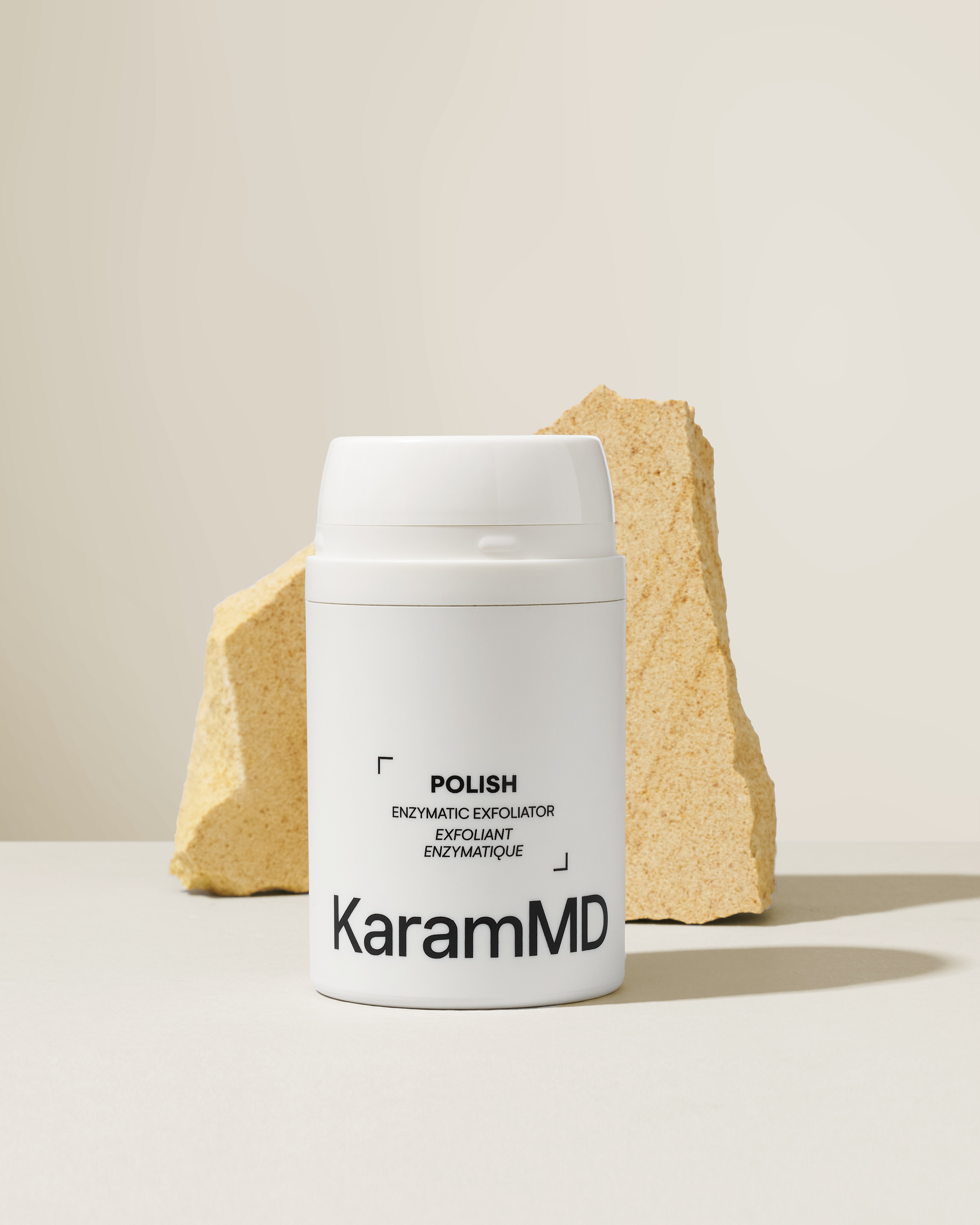 KaramMD Polish Enzymatic Exfoliator on a stone plinth