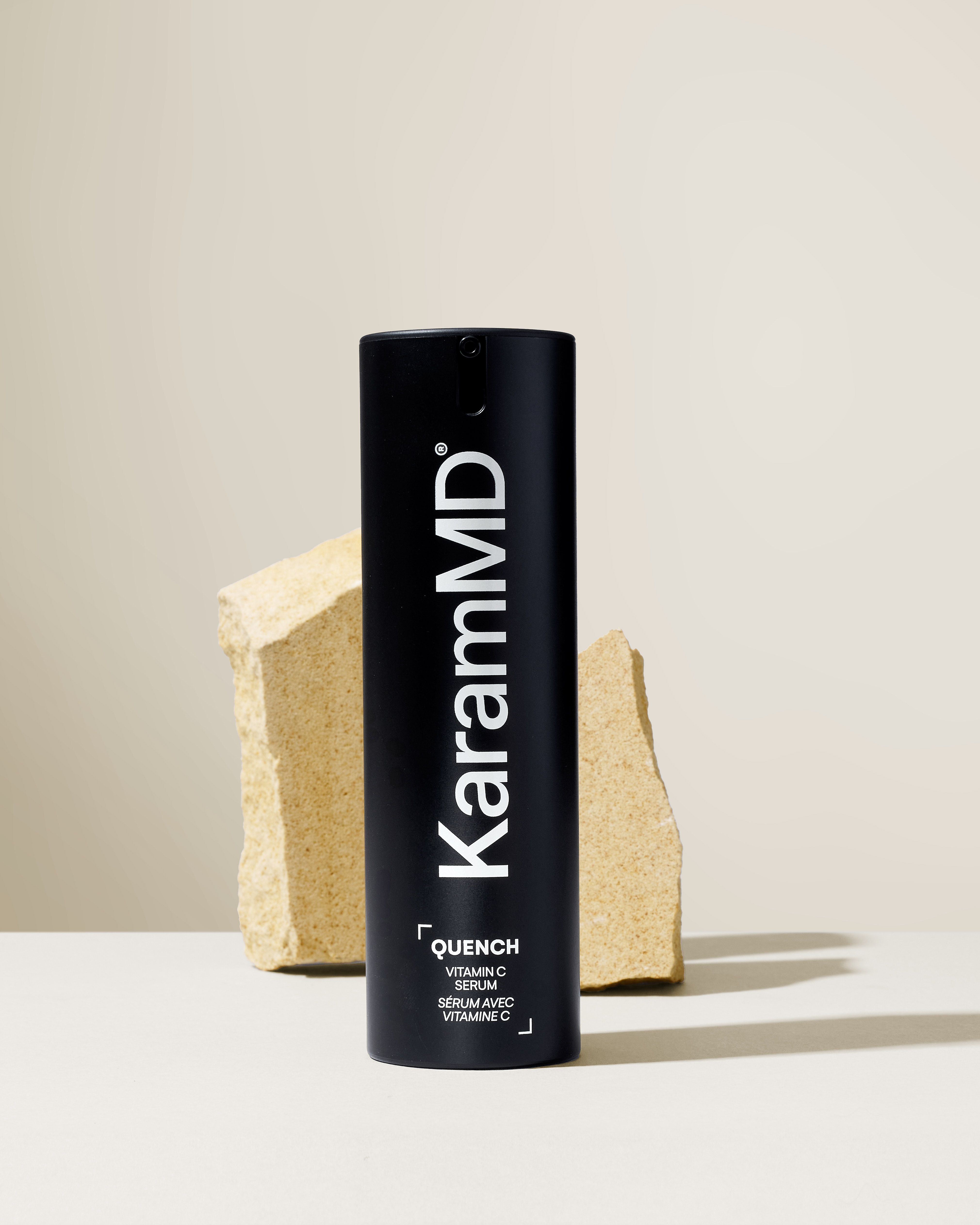 KaramMD Quench Vitamin C Serum on a stone plinth