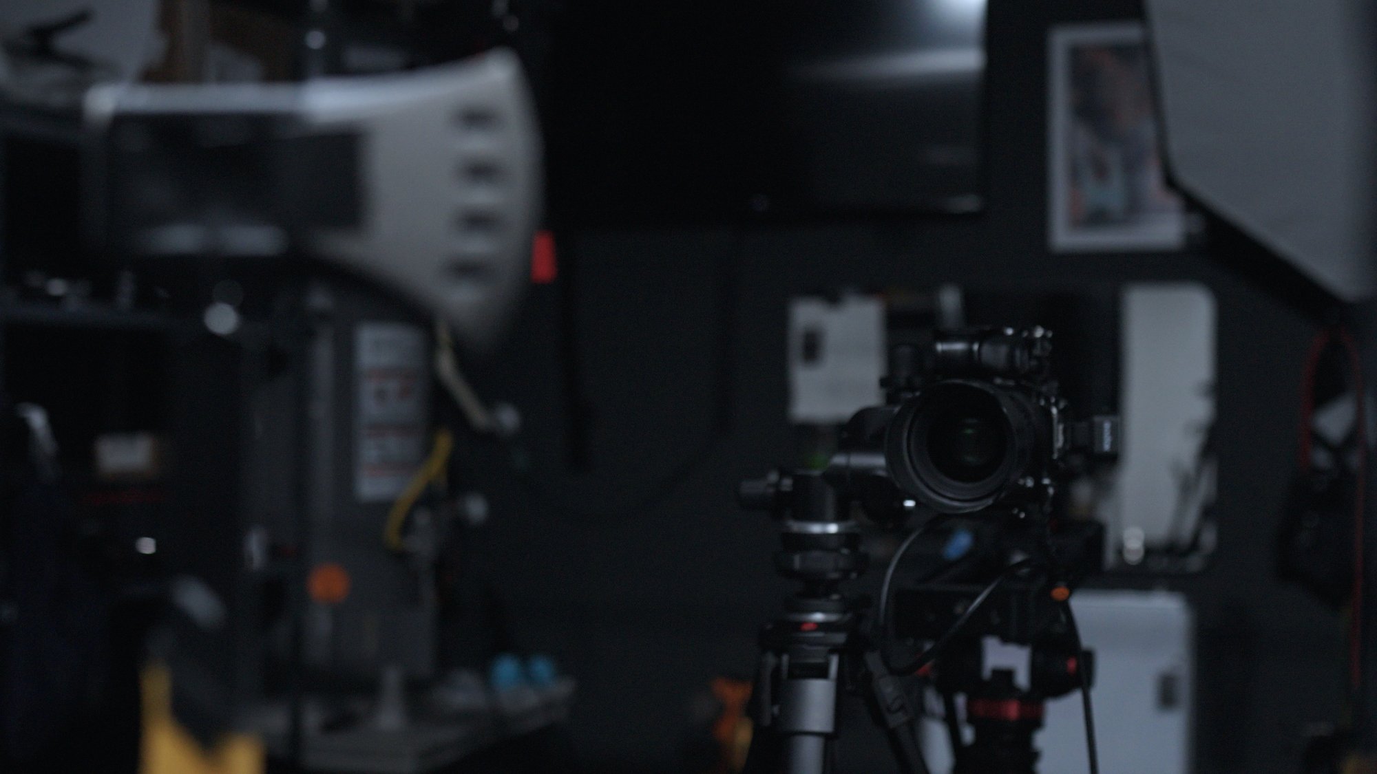 The set — camera on tripod aimed at the suspended hatchet, strip softbox and stands in a dark studio
